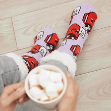 Load image into Gallery viewer, The Foozie™ Marshmallow slipper socks, worn on a wooden floor with hands holding a mug topped with marshmallows