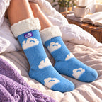 The Foozie™ Cloud slipper socks, on a cosy duvet