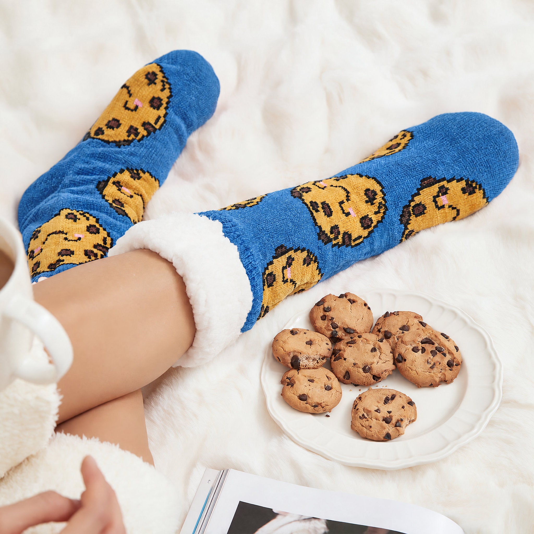 The Foozie™ Cookie slipper socks, with a plate of cookies