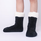 The Foozie™ in Black, front view of both feet worn in Kids/Small with the sherpa cuffs folded down